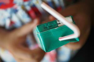 child drinking juice box top view photo