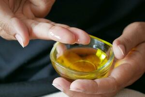 women hand using olive oil photo