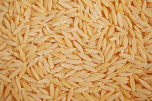 top view of brown long rice on table . photo