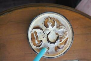 top view of iced late in a transparent glass on cafe table outdoor photo