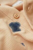 closeup of shirt with blue ink stain . photo