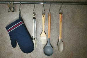Cooking utensils hanging out with copy space photo
