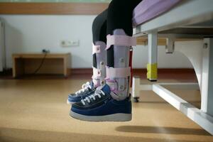 Child cerebral palsy disability, legs orthosis. photo