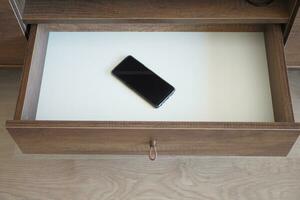 mobile phone in open drawer. photo