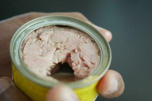 canned tuna on wooden table , photo