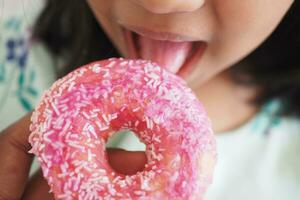 child mouth eating chocolate donuts photo