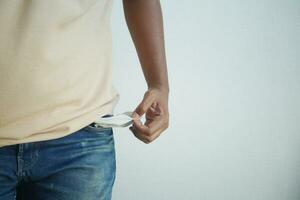 young man shows empty pant pocket with copy space photo