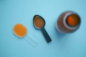 cough syrup on a plastic spoon photo