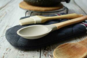 wooden cutlery forks and cooking pan on table photo