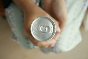 top view of women holding a soft drinks can . photo