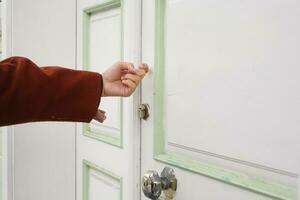 young women hand knocking door, photo