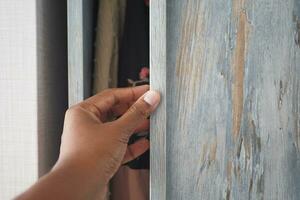 hand opening bedroom cabinet door photo