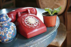 red color Retro telephone on table. photo