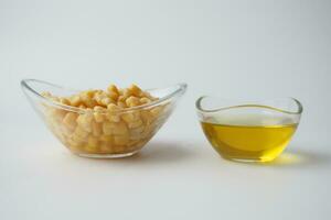 Corn oil with fresh corn on table photo