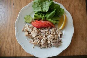 Shred boiled chicken breast. Boiled chicken breasts photo