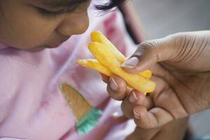 child eating french fries close up photo