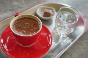 a cup of turkish coffee on table photo