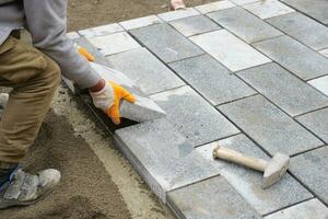 laying concrete bricks on each other for building a new sidewalk in istanbul photo