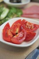 cherry tomato slices on table photo