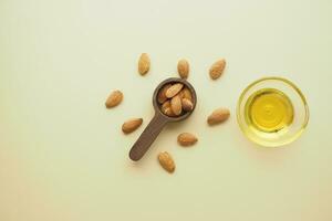 almond oils and fresh nuts on table photo