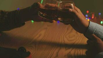 Close up of two people are cheering with cocktails in a bar or disco club. video