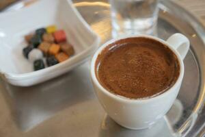 a cup of turkish coffee on table photo