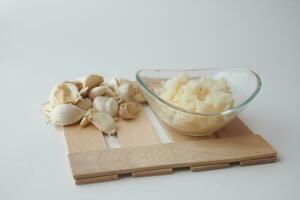 close up of minced garlic on a wooden spoon photo