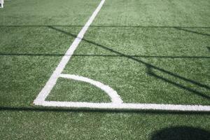 Closeup of Corner kick line of football and soccer field, background texture photo