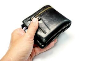 Closeup hand of human holding a black men's leather wallet isolate on white background and make with paths. photo