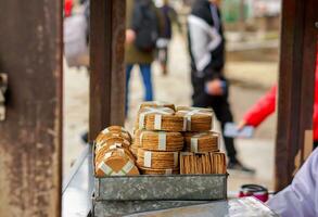 Closeup heaps of Japanese cracker Sembe for sell in a small booth to feed deer in Nara park natural, Nara, Japan. photo