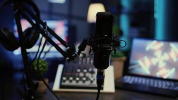 Panning shot of high tech mic used to produce quality online show for livestreaming channel. Professional streaming sound capturing and recording podcasting gear in empty apartment, close up video