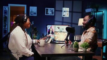 Woman radio show presenter having live conversation with man, recording discussion for audience listening live. Influencer enjoying chat with journalist, broadcasting discussion for fans at home video