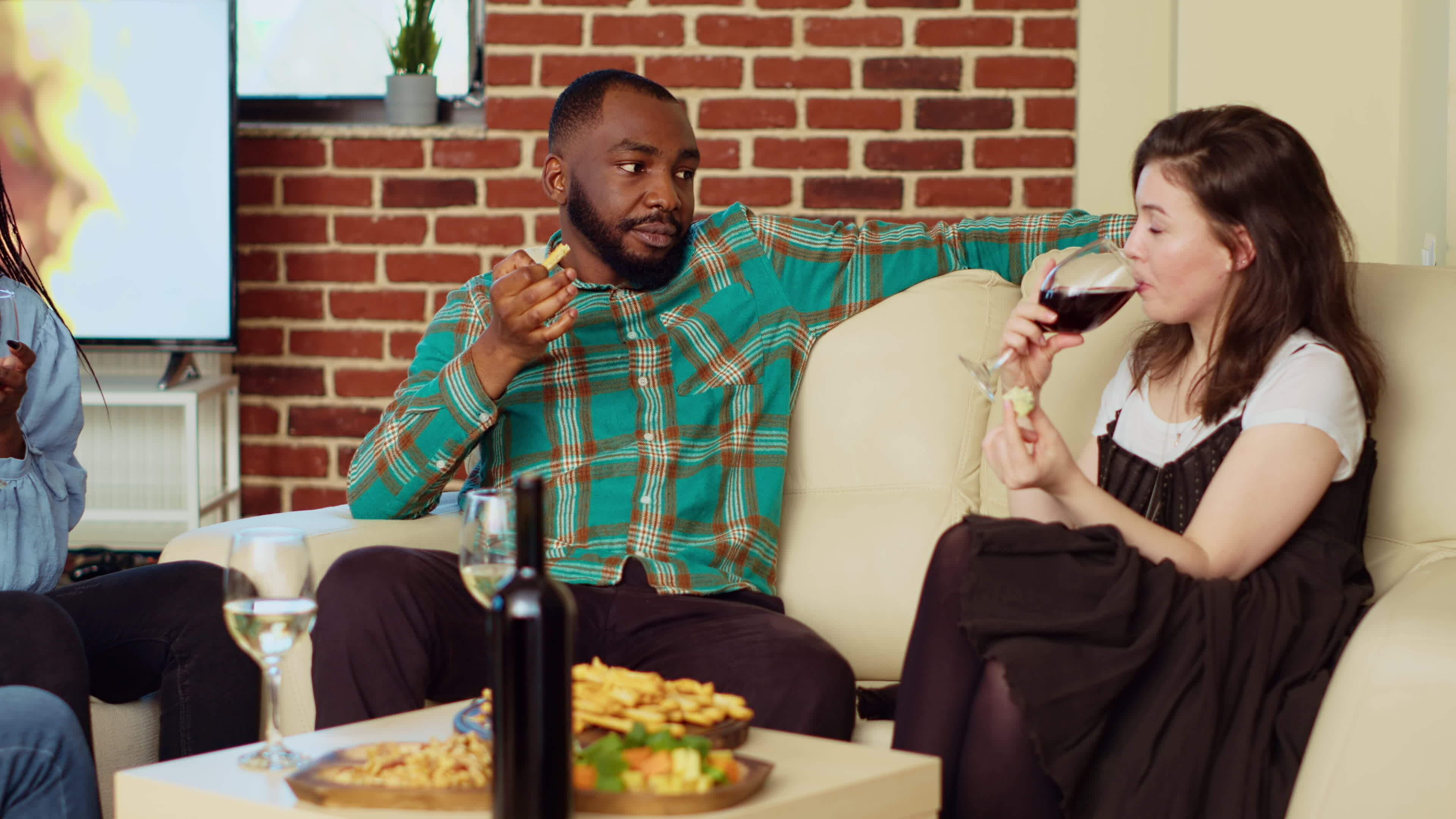 African american man flirting with woman on couch at apartment party