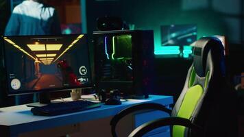 Man arriving in dark living room, ready to play science fiction videogame on computer. Gamer sitting on gaming chair, battling flying robots with futuristic gun in singleplayer shooter video