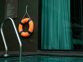 lifebuoy safety water sea ocean boat river waterfall rescue buoy summer spring autumn winter season time holiday vacation hotel resort condominium apartment building swimming pool security orange help photo
