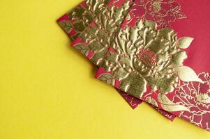 Chinese New Year red packets on yellow cover background with customizable space for text photo