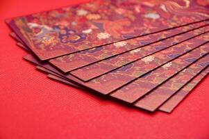 Close up of Chinese New Year red packets on red cover background with customizable space for text photo