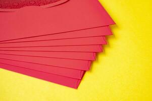 Red envelopes on yellow cover background with customizable space for text photo