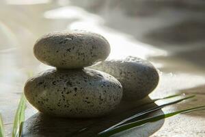 Light shining on zen stones with customizable space for text. Copy space. photo