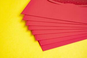 Chinese New Year red packets on yellow cover background with customizable space for text. photo