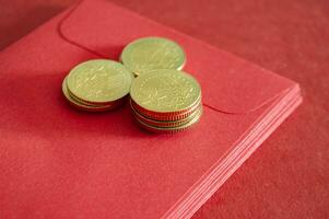 Gold coins on top of Chinese New Year red packets. photo