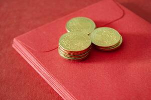 Gold coins on top of Chinese New Year red packets photo