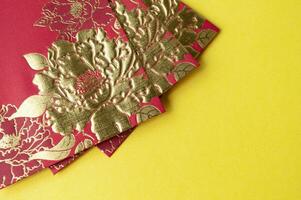 Chinese New Year red packets on yellow cover background with customizable space for text photo