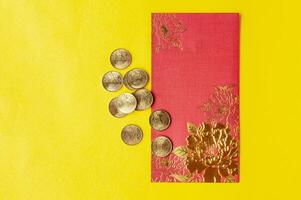 Top view of Chinese New Year red packets on yellow cover background. Customizable space for text. photo
