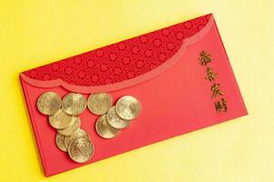 Top view of Chinese New Year red packets on yellow cover background photo