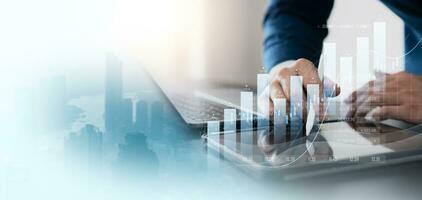 finance with a professional businessman use using laptop and tablet analyzing financial data, graph growth chart in action. perfect business plan, strategy, and solution. photo
