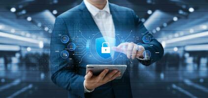 Cybersecurity and data protection, businessman use secure tablet encryption technology, protect business and financial transaction data from cyber attacks, intelligent protection digital attacks. photo