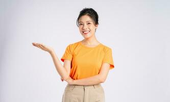Portrait of cheerful happy Asian woman posing on white background photo