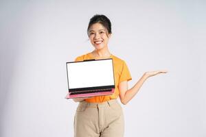 Portrait of cheerful happy Asian woman posing on white background photo