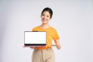 Portrait of cheerful happy Asian woman posing on white background photo